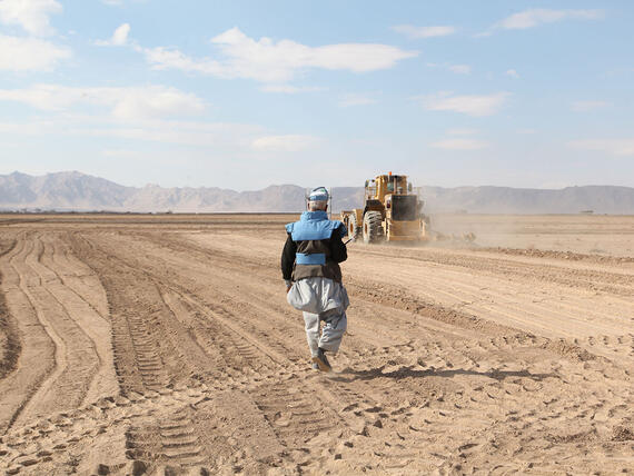 A sign warning of unexploded ordnance in a field in Syria.